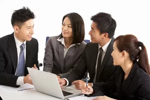 pngtree-chinese-businesspeople-discussing-strategy-in-modern-hong-kong-office-setting-photo-photo-image_69675022